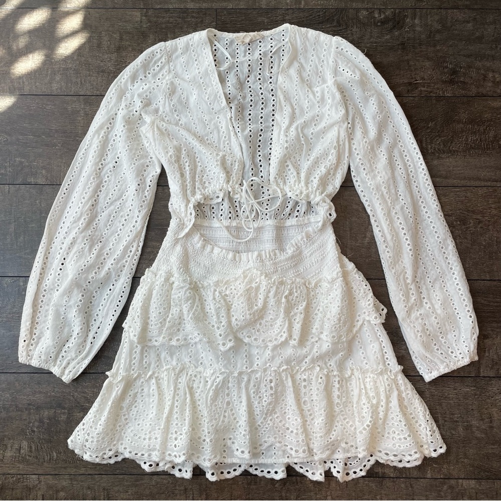 White eyelet v-neck long-sleeve open-waist mini-dress with short ruffle bottom
